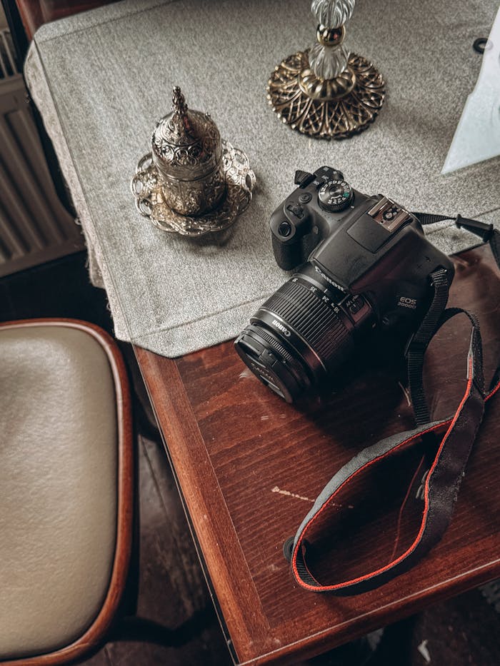 Cozy indoor scene with camera and ornate tea set on a wooden table